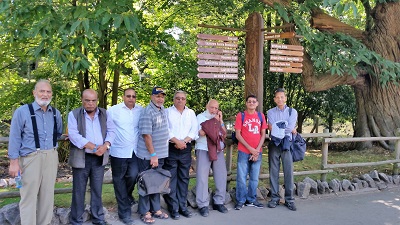 Men in front of tress